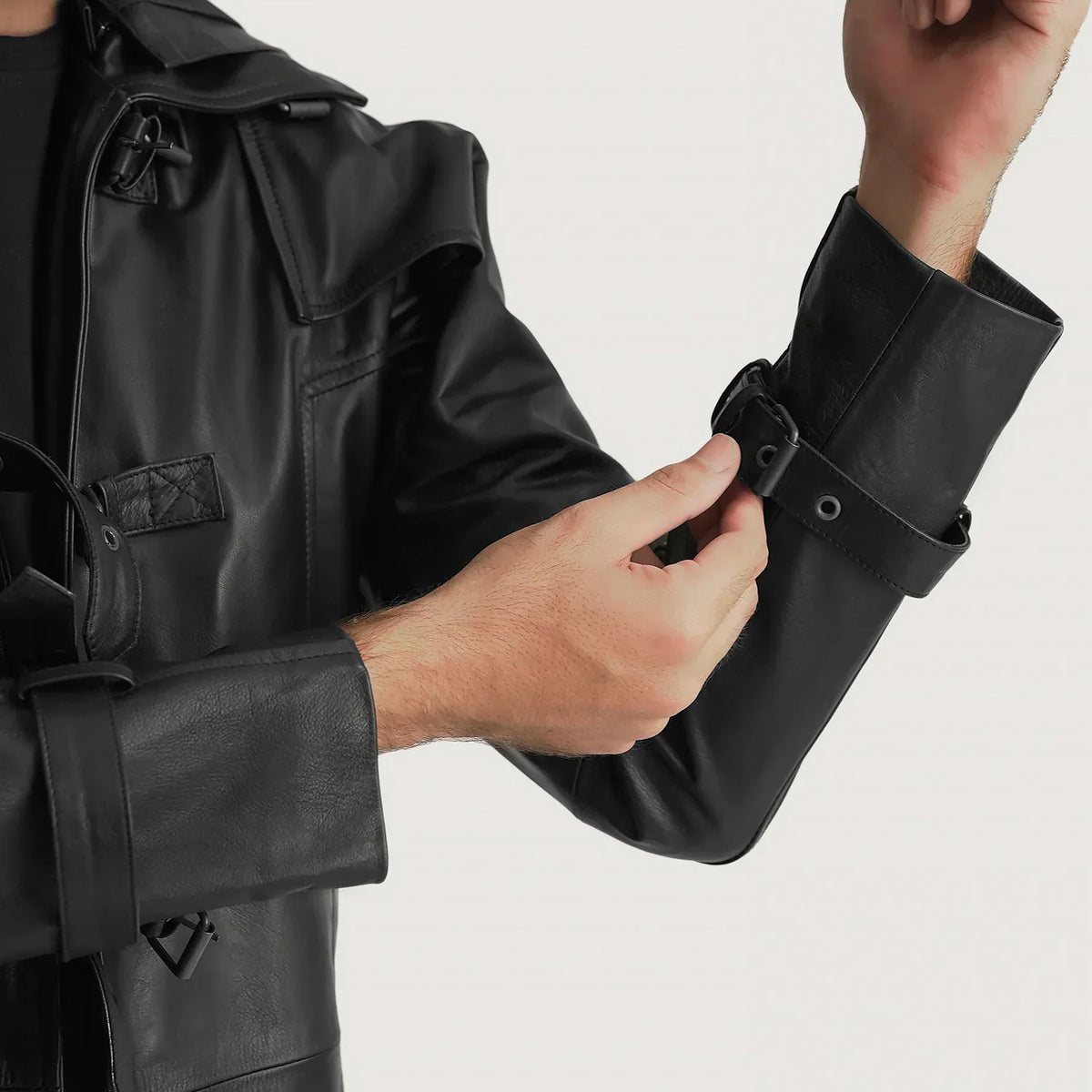 
Close-Up Detail of Shirt collar with a large hood & Belted Hardware on Huntsman Black Hooded Leather Trench Coat